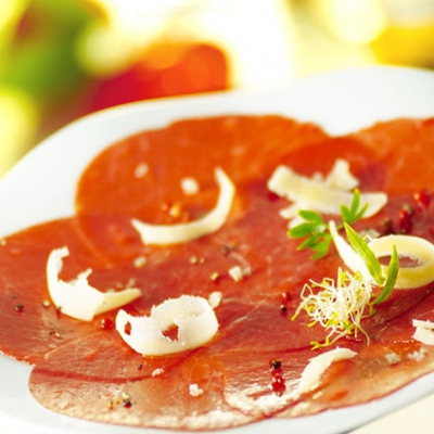 Beef Carpaccio with roasted nuts, aromatic olive oil, and rocket salad with cider vinaigrette - 